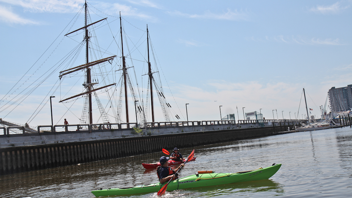  Joseph Smith and Laurie Huselton with the Coast Guard Auxiliary paddle on the Delaware River near Penn’s Landing. (Kimberly Paynter/WHYY) 