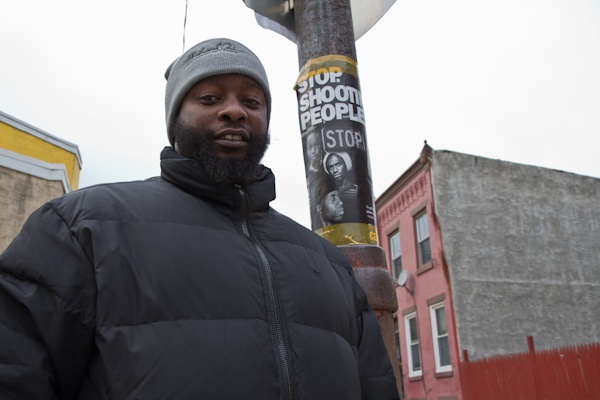 CeaseFire Philadelphia outreach coordinator Quinzel Tomoney canvases the site of a recent shooting. (Kimberly Paynter/For NewsWorks)