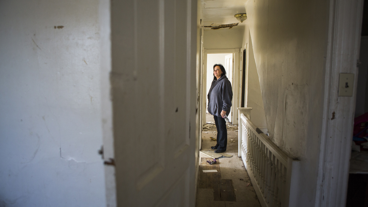  Debbie DeSimone stands in the second floor hallway of the last home that needed to be renovated on Rose Street. (Jessica Kourkounis/For Keystone Crossroads) 