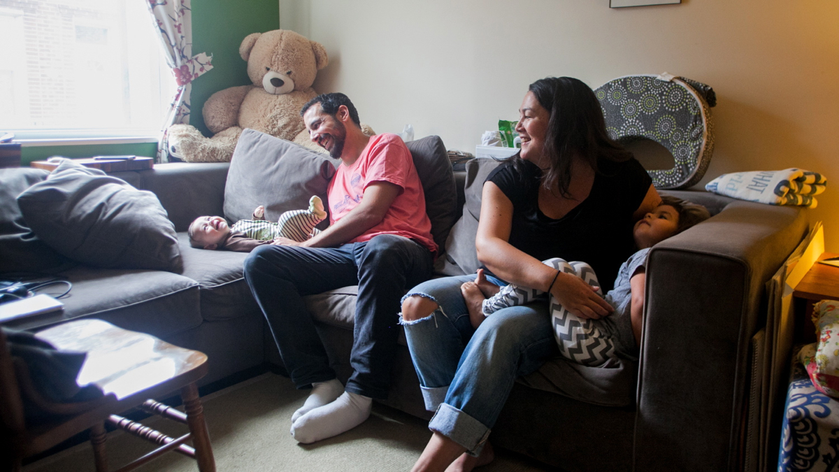  Jonathan Mosca and wife Michi Hunt play with their children, three-month-old Aiko and three-year-old Nori, in their South Philadelphia Home. (Brad Larrison for NewsWorks) 