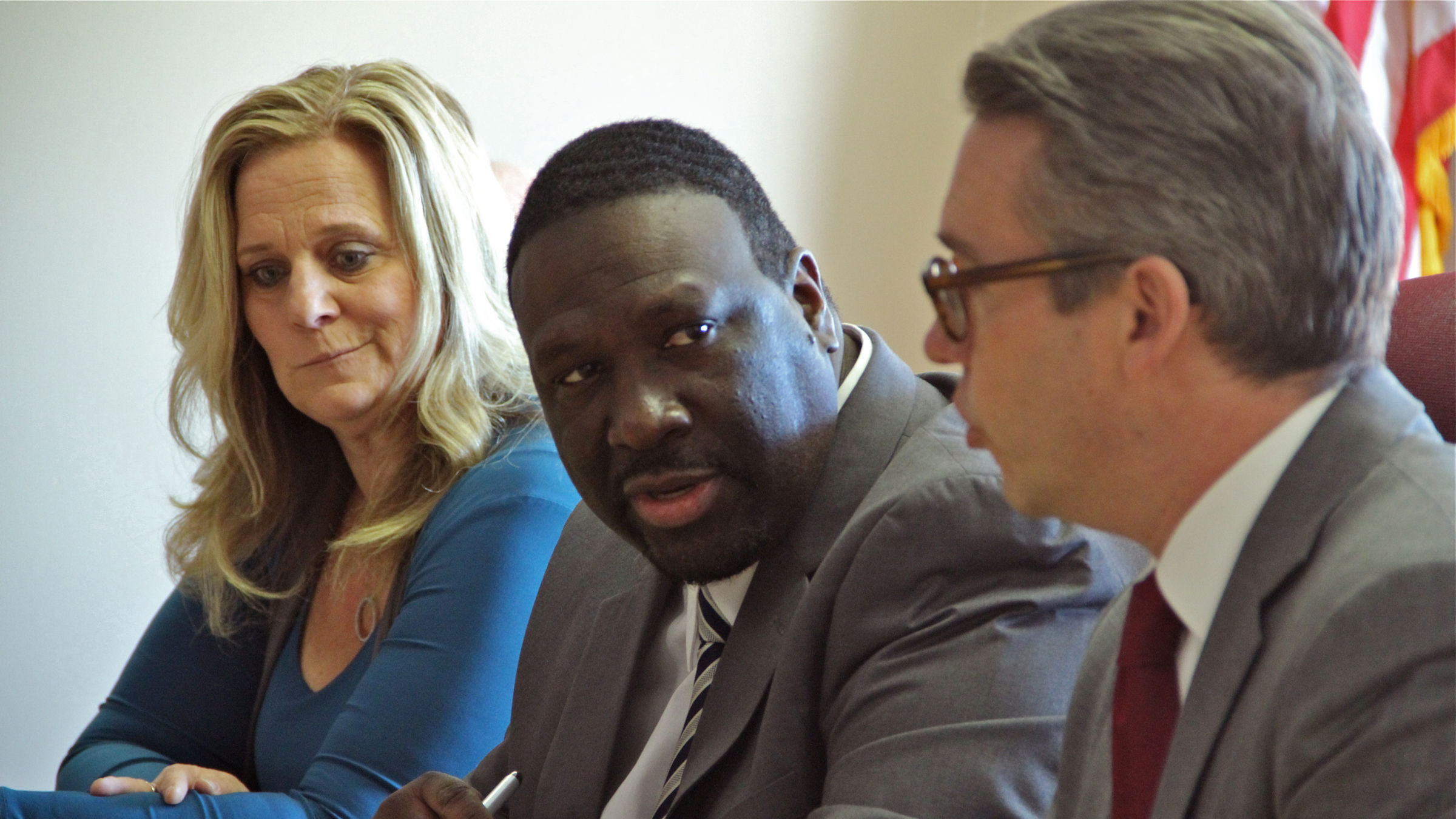  Anthony Clark (center) was re-elected chair of the Philadelphia City Commissioners by fellow commissioners Lisa Deeley (left) and Al Schmidt (right). (Emma Lee/WHYY) 