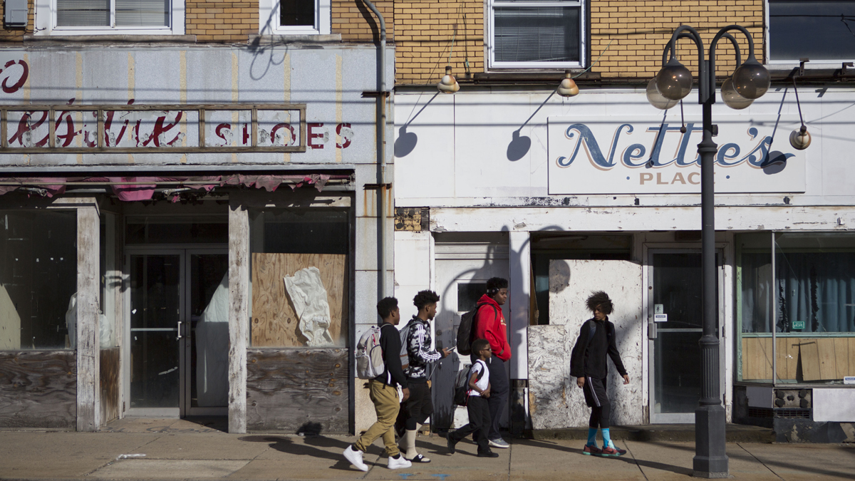  Kids walk down Miller Avenue passed shuttered businesses in downtown Clairton, Pennsylvania. (Jessica Kourkounis/For Keystone Crossroads) 