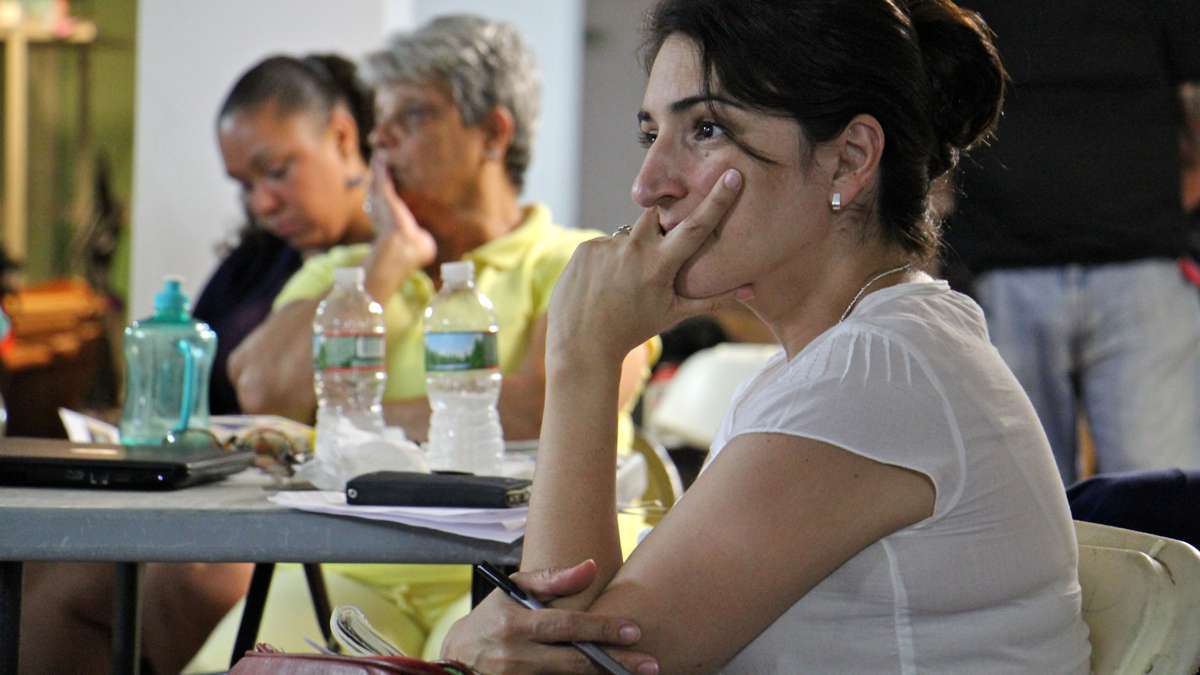 Patricia Codina, community development director at Impact Services, attends a meeting to discuss the Guerney Street clean up project. (Emma Lee/WHYY)