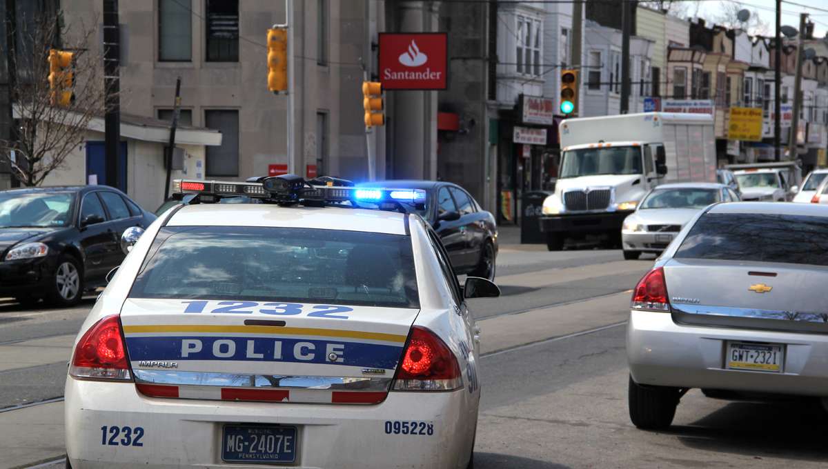 A police cruiser pulls onto Woodland Avenue in Southwest Philadelphia.