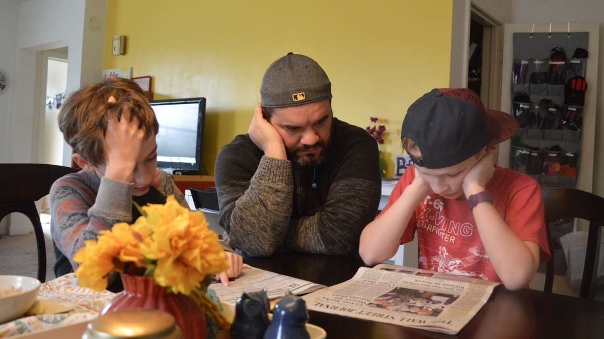  Eric Bennion said he thinks the morning routine of reading and discussing the newspaper every day before breakfast with his two sons enables better communication between them. (Max Green/for WHYY) 