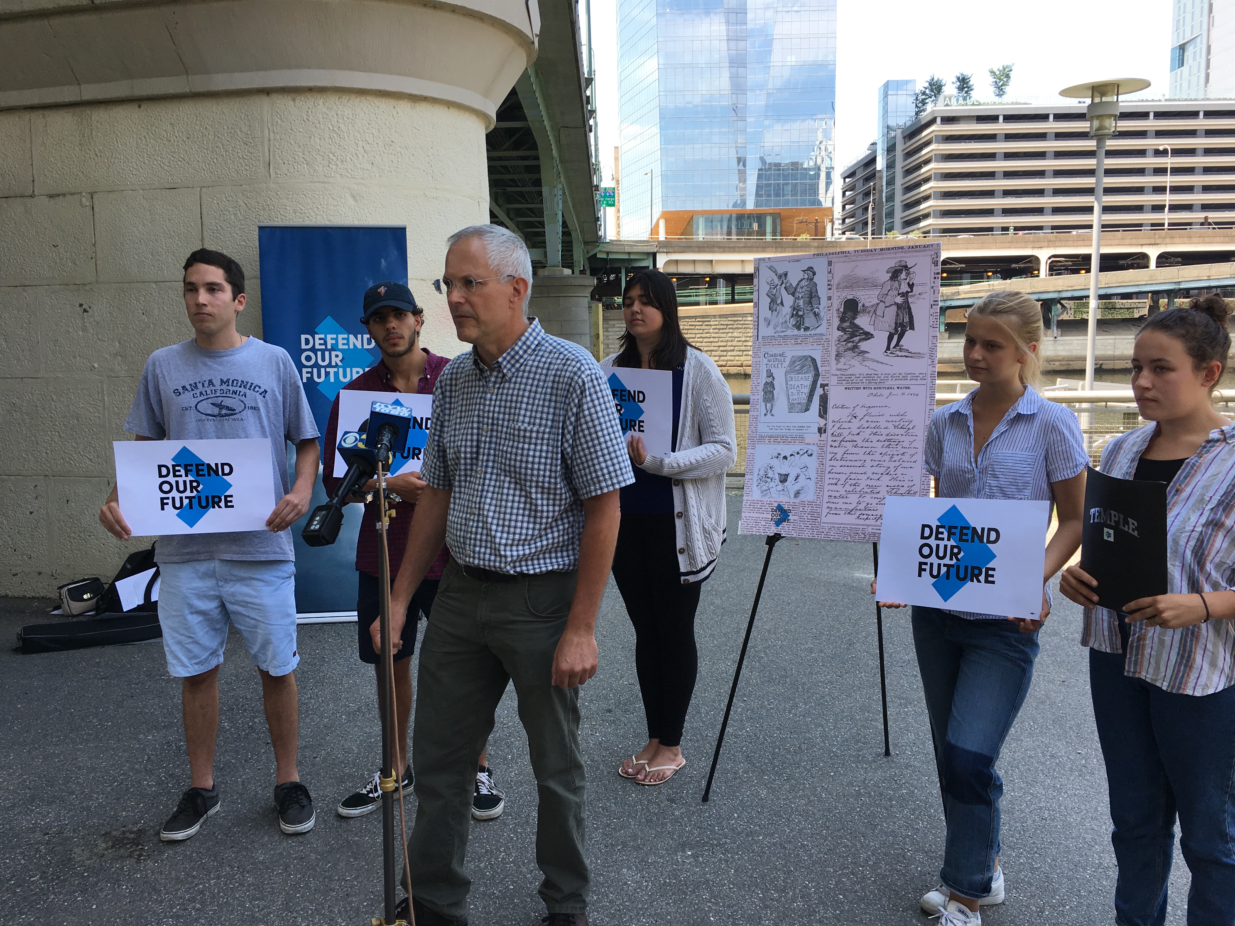  Demonstrators gather on the banks of the Schuylkill River to call  for continued EPA funding. (Tom MacDonald/WHYY) 