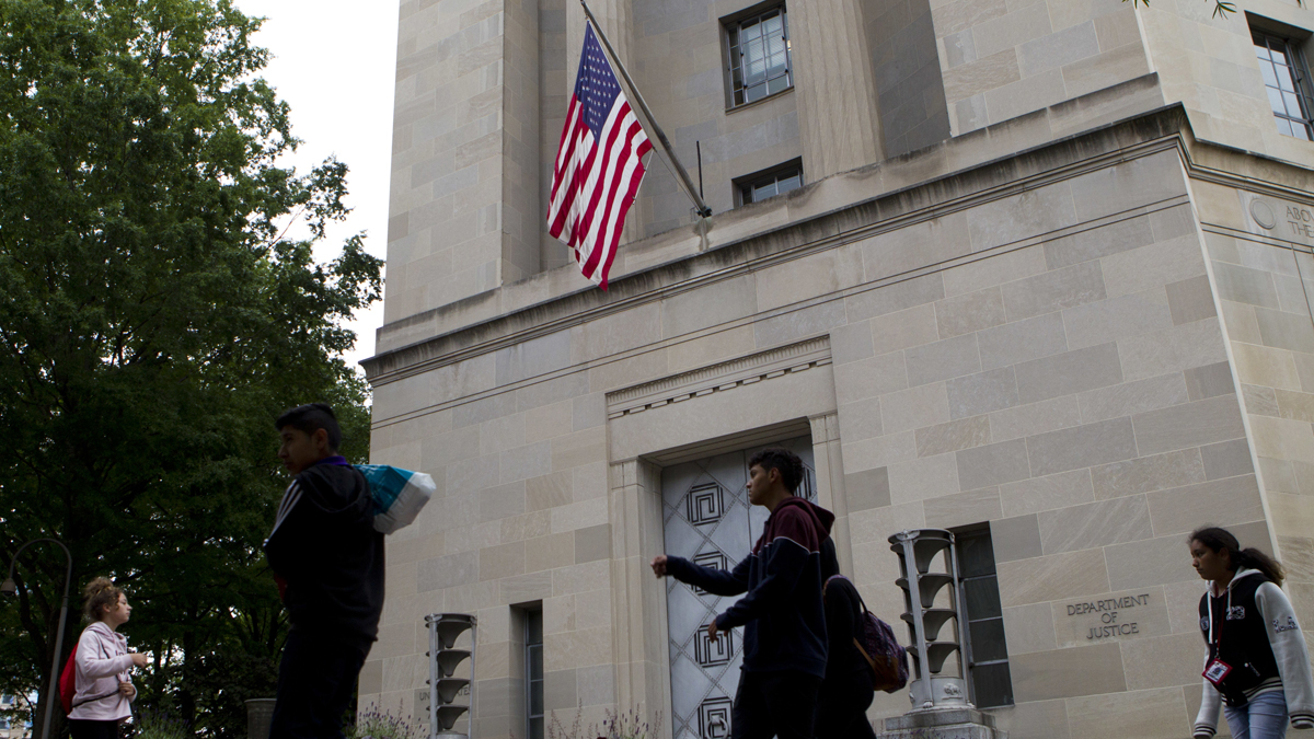 People walk outside the U.S. Department of Justice on Saturday, May 13, 2017. Attorney General Jeff Sessions and his deputy, Rod Rosenstein, interviewed several candidates to succeed ousted FBI Director James Comey at Justice Department headquarters on Saturday. (AP Photo/Jose Luis Magana) 