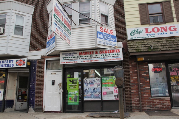 <p>Bakayoko Ben Hassan does a lot of business selling smartphones and other mobile internet devices at his shop on Woodland Avenue. (Emma Lee/for NewsWorks)</p>
