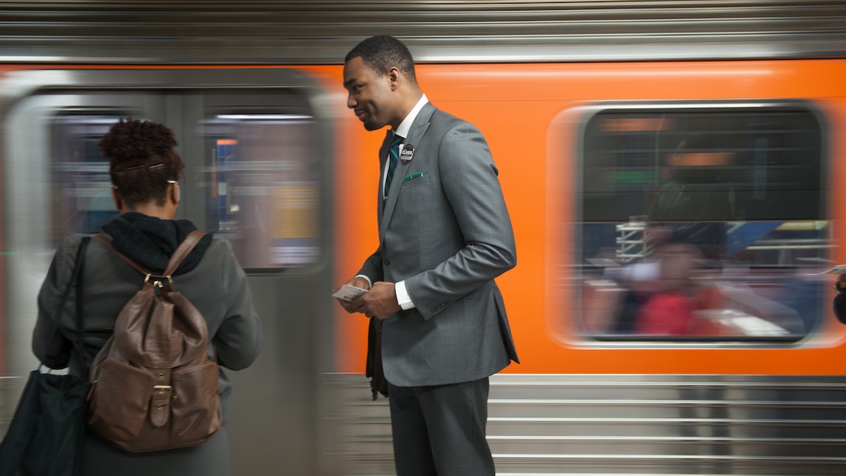 Mayoral candidate Doug Oliver talks with a passenger on the Broad Street subway line during his Monday morning canvas at the Olney station. Oliver has been campaigning on Septa trains and buses since January.