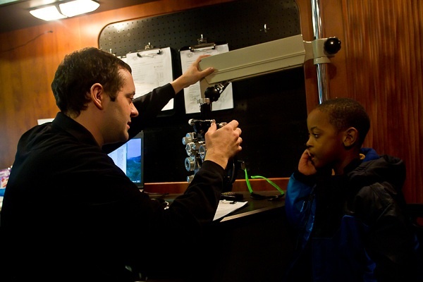 <p><p>Dr. Carter Liotta from the Department of Ophthalmology at St. Christopher's Hospital For Children prepares to give Tyreese Mcclain an eye exam. (Brad Larrison/for NewsWorks)</p></p>
