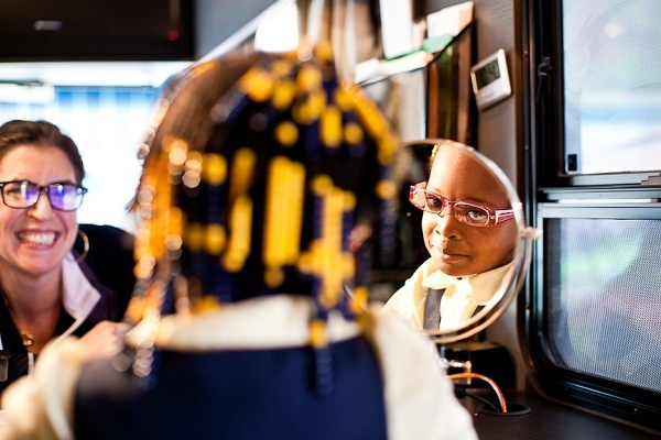 <p><p>Shamaya Combs-Simmons of Wister School checks out her new pair of glasses in the Eagles Eye Mobile on Tuesday. (Brad Larrison/for NewsWorks)</p></p>
