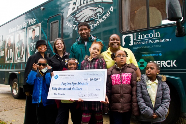 <p><p>Students from Wister School pose for a picture with Akeem Jordan of the Philadelphia Eagles and Lorina L. Marshall-Blake of Independence Blue Cross. (Brad Larrison/for NewsWorks)</p></p>
