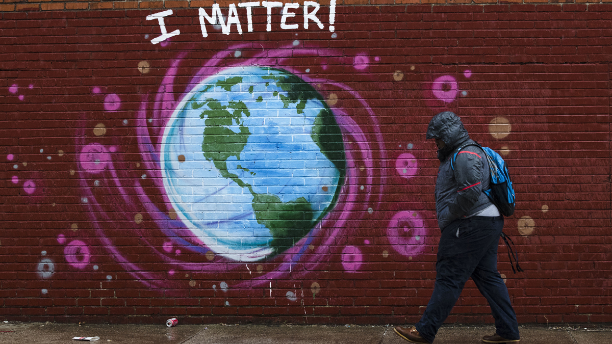  A man walks past a mural the day before Earth Day, in Philadelphia, Friday, April 21, 2017. (AP Photo/Matt Rourke) 