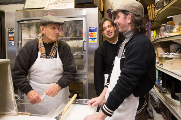 Philip Mancuso (left) pulls fresh mozzarella with sons Joe and Larry at L. Mancuso & Son cheese shop on East Passyunk Avenue. (Lindsay Lazarski/WHYY)