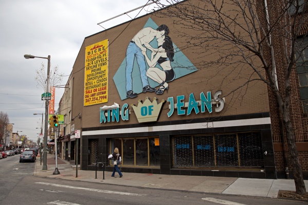 The building that housed the former King of Jeans clothing store is under construction and expected to become retail space and apartments. Some residents wonder what will happen to its iconic sign. (Lindsay Lazarski/WHYY)
