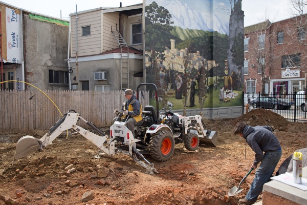 Workers renovate the lot next to Le Virtu restaurant. Co-owner Francis Cratil says the lot will be used as an open green space for dinner and events, and will include an herb garden for the restaurant's kitchen. (Lindsay Lazarski/WHYY)