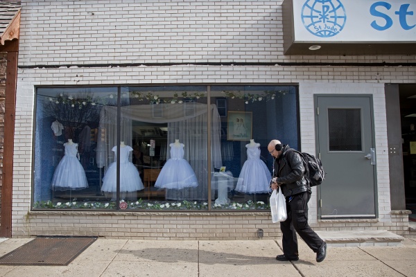 First Communion dresses adorn the window at St. Jude Shop, Inc. on East Passyunk Avenue. (Lindsay Lazarski/WHYY)