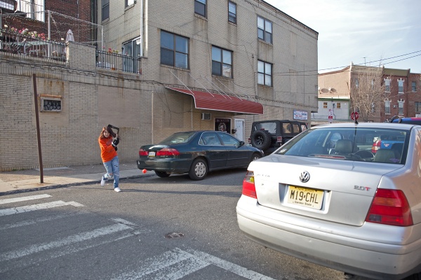 Chelsea DeRock practices her slap shot on a side street off of the East Passyunk corridor. (Lindsay Lazarski/WHYY)