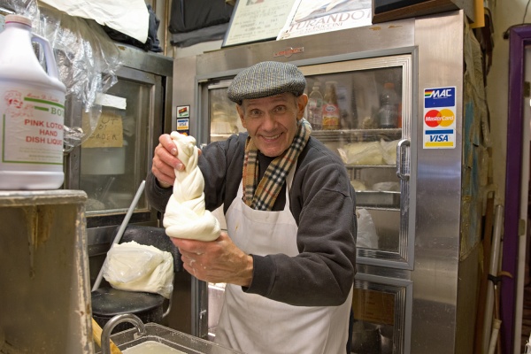 Philip Mancuso makes fresh mozzarella in the back of his cheese shop, L. Mancuso & Son. (Lindsay Lazarski/WHYY)