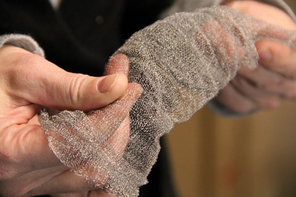 <p><p>Geneviève Dion holds a sleeve knitted from silver wire, which may hold the future of robotics. (Emma Lee/for NewsWorks)</p></p>
