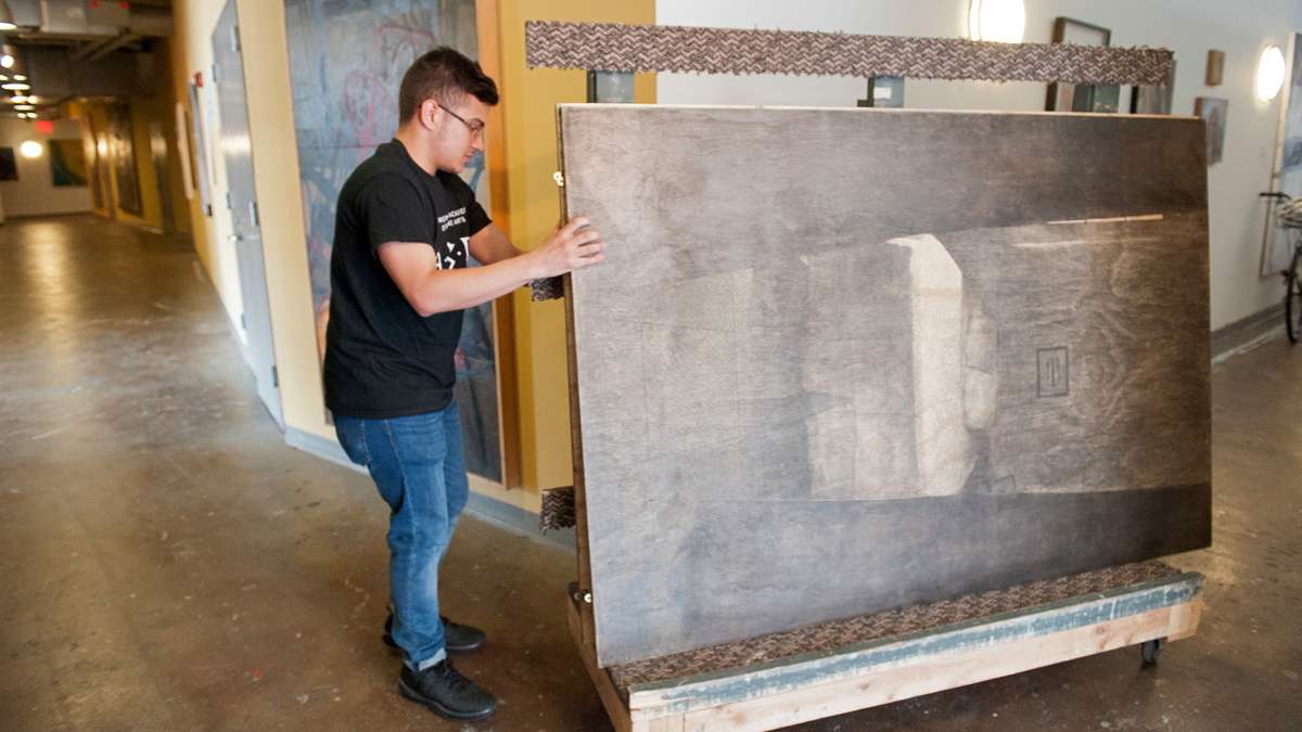 Diego Rodriguez Carrion moves his paintings from his studio to the gallery.