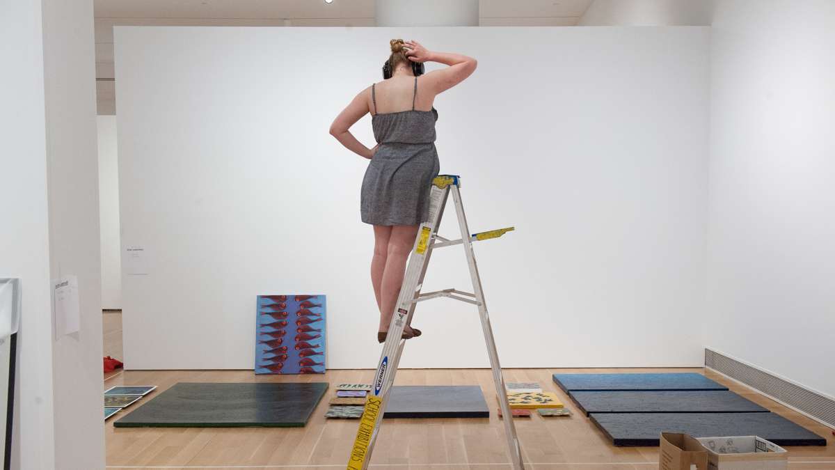 Olivia Losee-Unger contemplates the layout of her artwork.