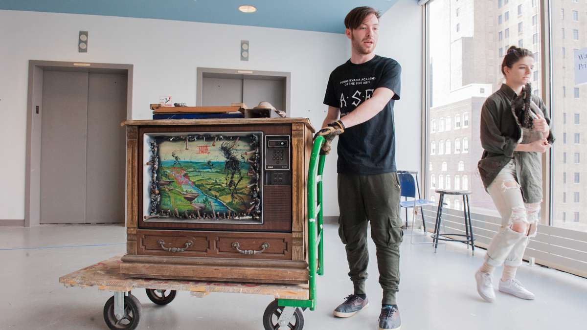 Michel Amabile (left) and Julia McGehean move some of Amabile's sculptures from his studio to the gallery.