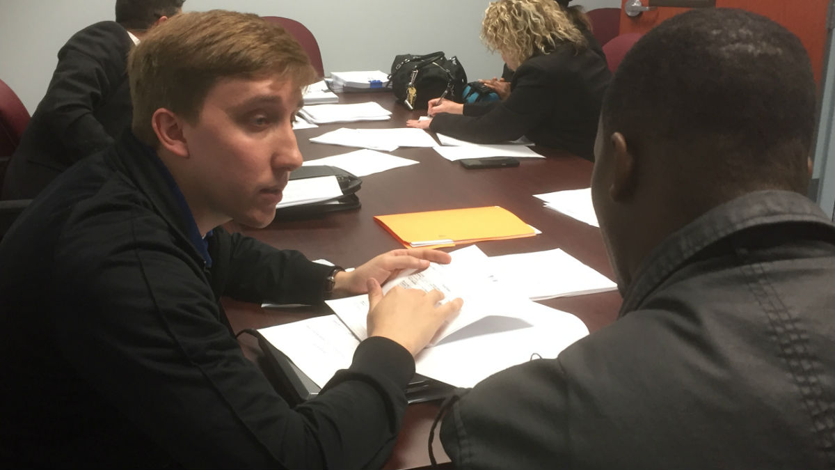  Two men talk at the expungement clinic in Dover Monday afternoon. (Zoe Read/WHYY) 