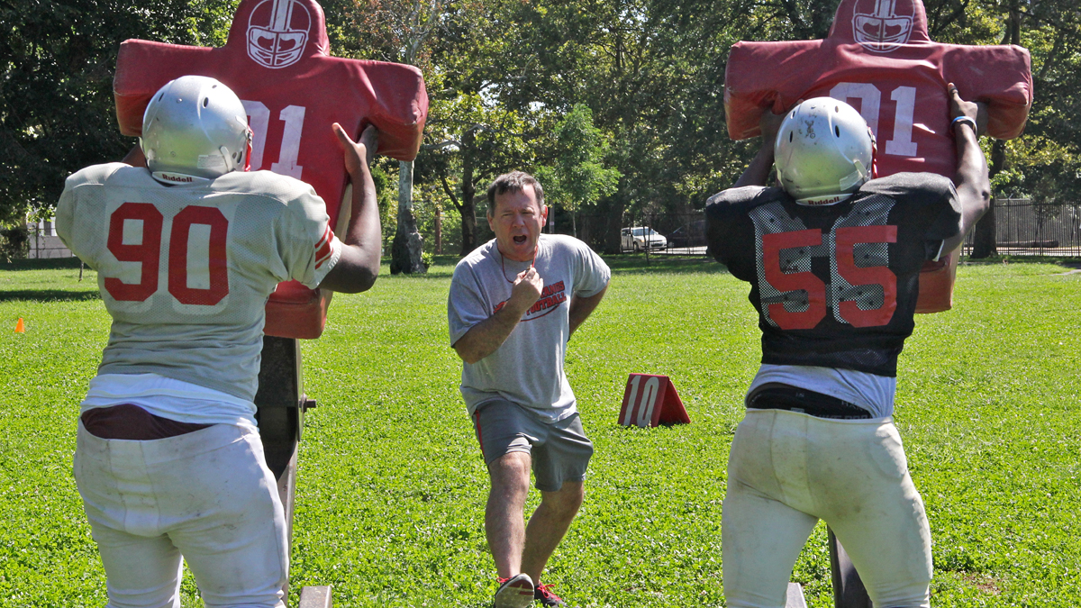  Mustangs coach John Sullivan runs a summer practice at Dobbins-Randolph Vo-Tech High School. (Emma Lee/for WHYY) 