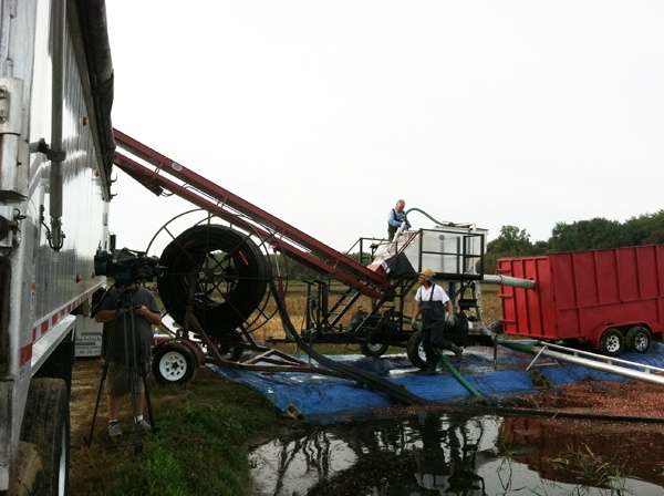 <p>Cranberry grower Tim Johnson washes and sorts berries. Good berries go to the left into an 18-wheeler, bad ones go into the red container on right.</p>
