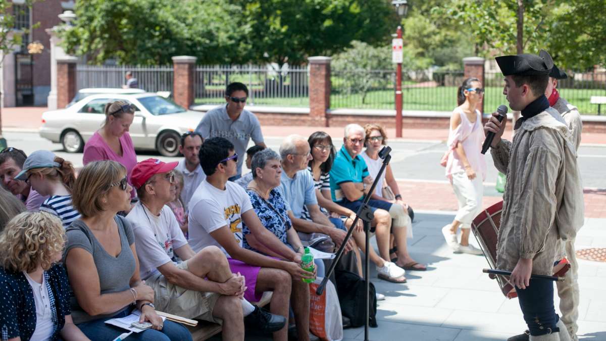 Matthew Skic, assistant curator of the fife and drum party, gives a brief history lesson on the use of music during the Revolutionary War. (Brad Larrison for NewsWorks)