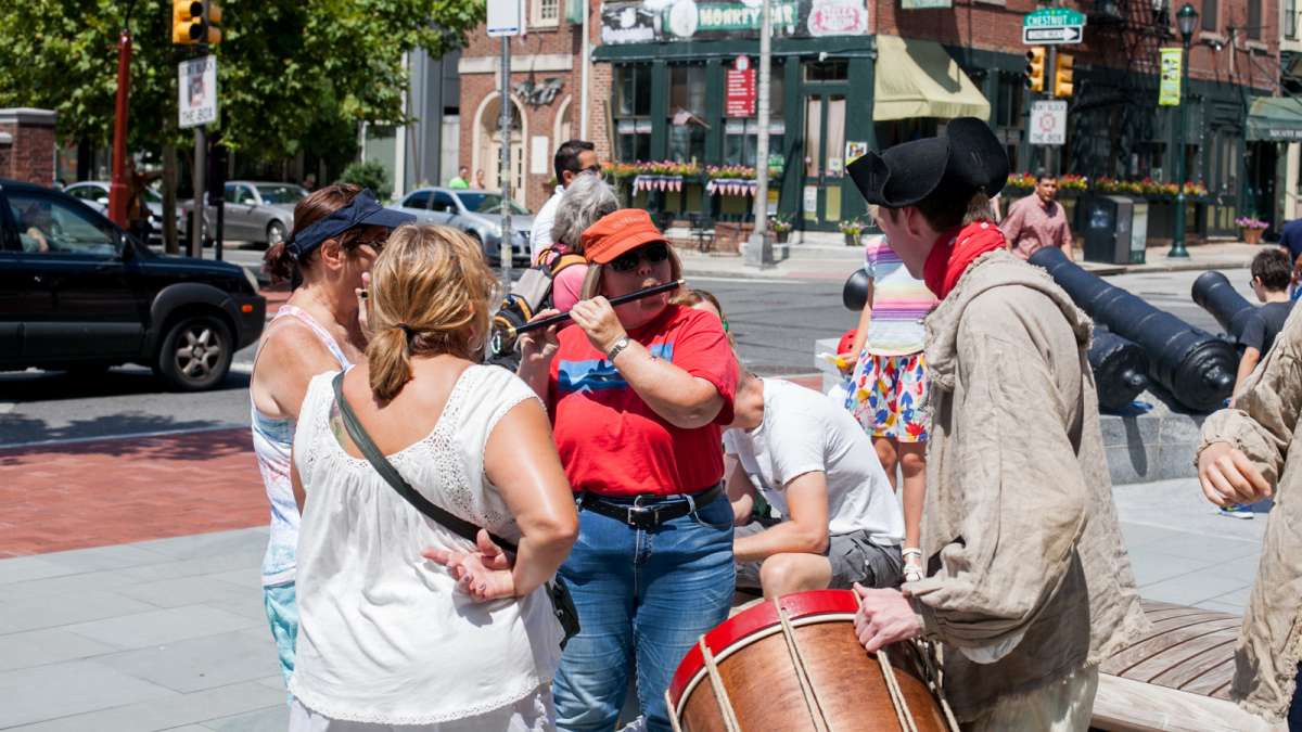 Museum goers have the chance to play a fife outside of the Museum of the American Revolution. (Brad Larrison for NewsWorks)