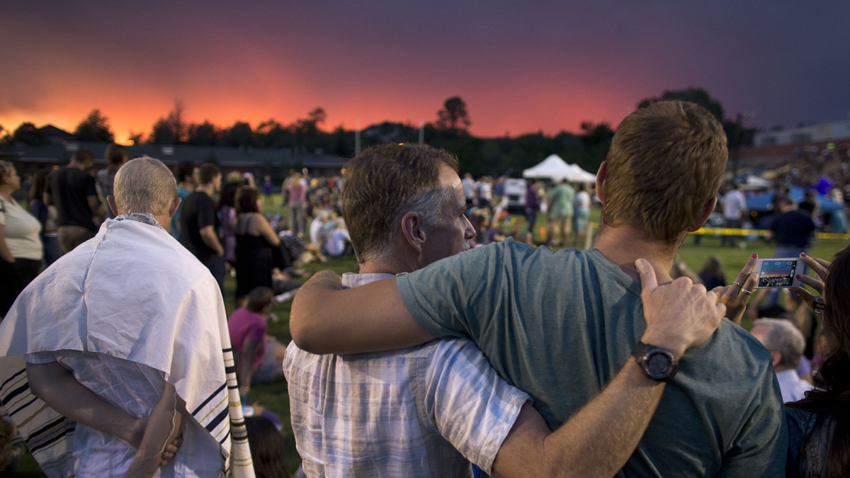  The sun sets as mourners gather for a candlelight vigil in Prescott, Ariz. Tuesday, July 2, 2013 to honor the 19 Granite Mountain Hotshot firefighters who were killed by an out-of-control blaze near Yarnell, Ariz. on Sunday. (AP Photo/Julie Jacobson) 