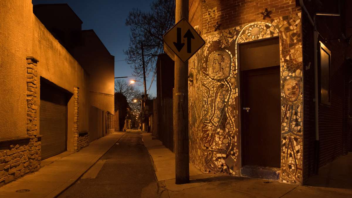 A broken-tile mosaic on a building in Norther Liberties glitters with the first light of dawn.