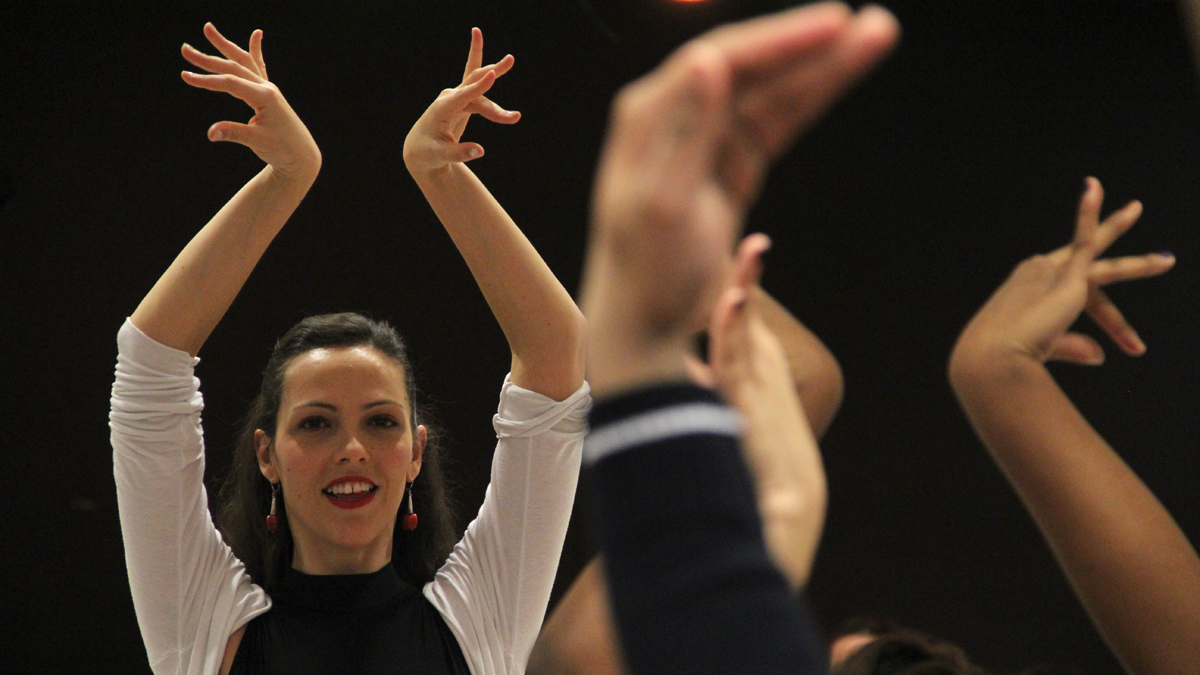  Luisa Serrano demonstrates the hand gestures of flamenco dancing for performing arts students at Nueva Esperanza Academy. (Emma Lee/for NewsWorks) 