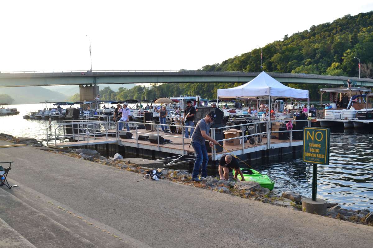 There are concertgoers in the water and on dry land. And some, like this kayaker, do a little bit of both. (Eleanor Klibanoff/WPSU)