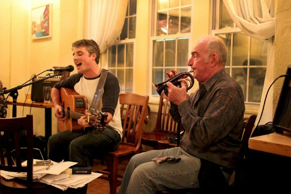 <p><p><span style="font-size: 11pt; font-family: 'Calibri','sans-serif';">Liam Gallagher, The Big Folkin' Experiment's co-host, and Jerry Allender start off the night with a Bob Dylan cover. (Corinne Warnshuis/ for NewsWorks)<br /></span></p></p>
