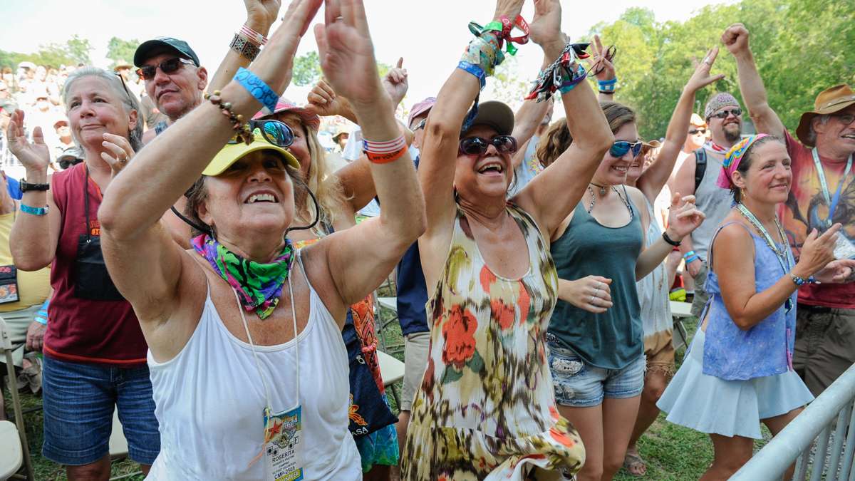 Roserita Frantoni (lef), and Nora Greenberg of Boca Raton, Florida, clap and dance to the music of Tempest.