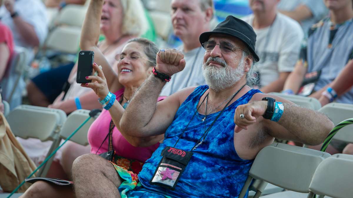 Audience members respond to a song performed by emcee Wesley Stace about Donald Trump's hair.