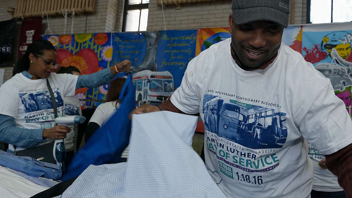 Volunteers from Comcast help sort through the donated clothes. (Bastiaan Slabbers/for NewsWorks)