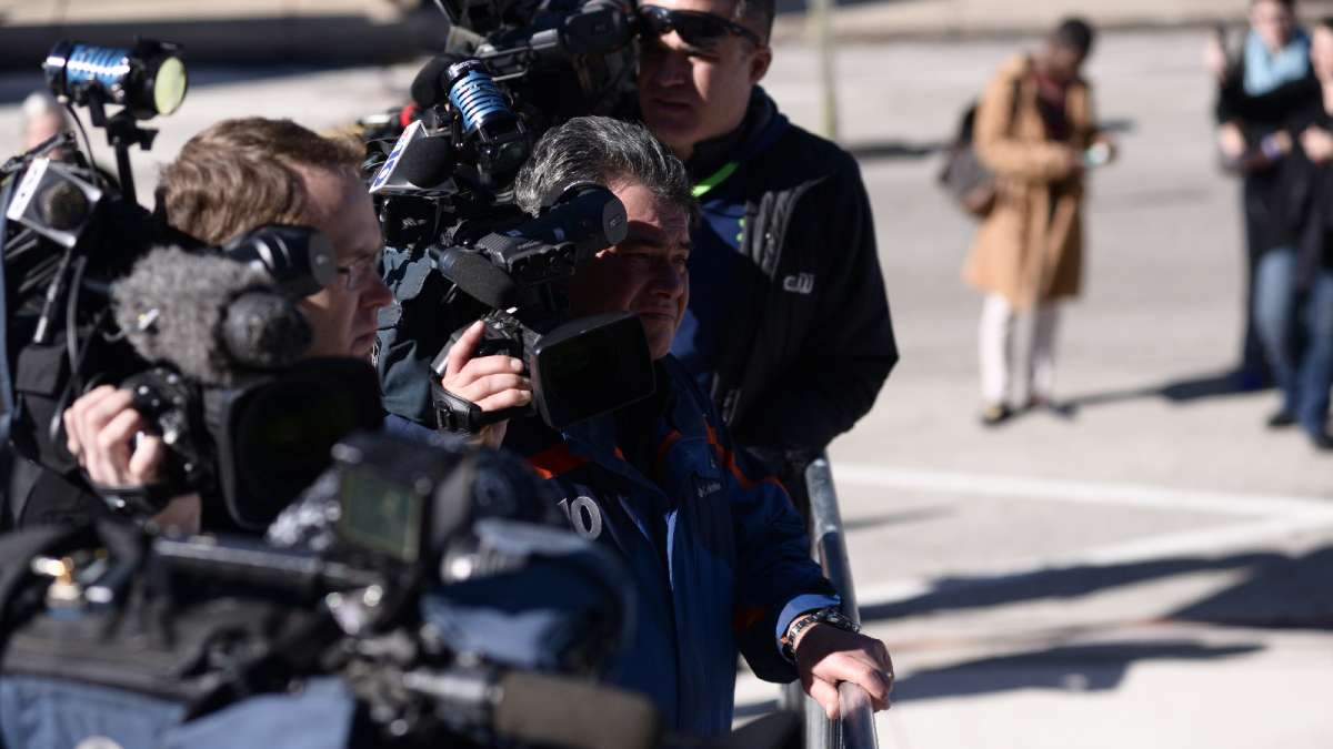 Camera operators wait on the courthouse steps as Cosby's hearing recesses at lunch time.