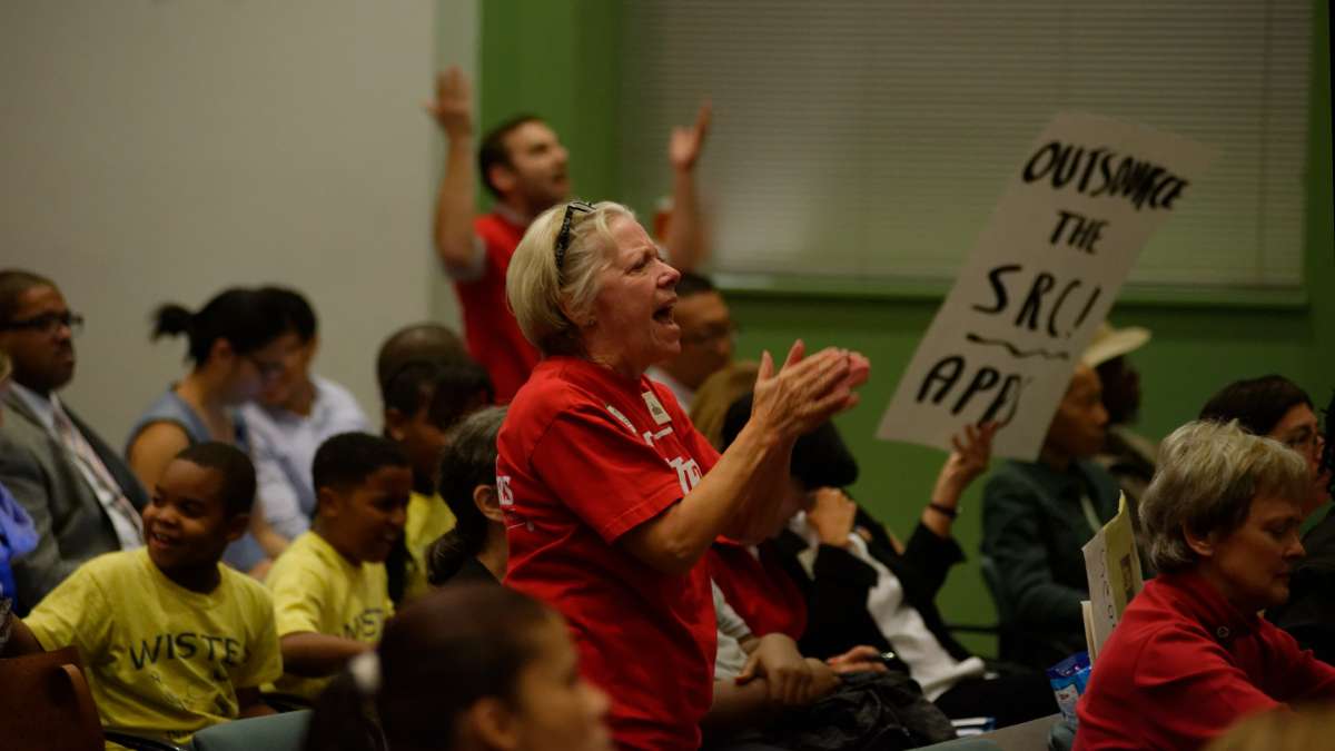 The audience is seen reacting.