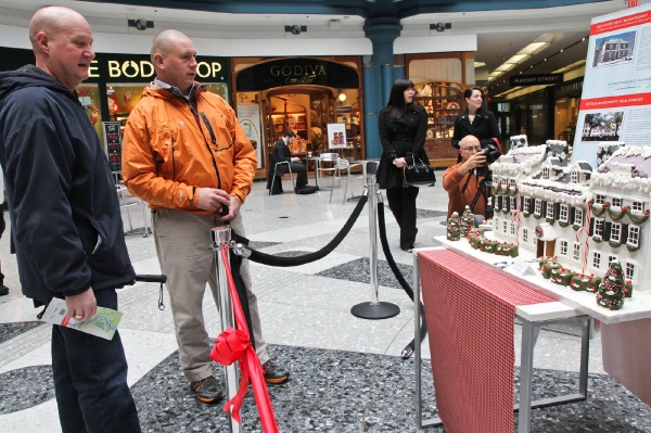 <p>Tim Kiser and Gil Hahn stopped by the display before a doctor's appointment and were impressed by The Strawberry Mansion gingerbread replica created by Angela Tustin of Plate Restaurant & Bar. (Kimberly Paynter/for NewsWorks)</p>
