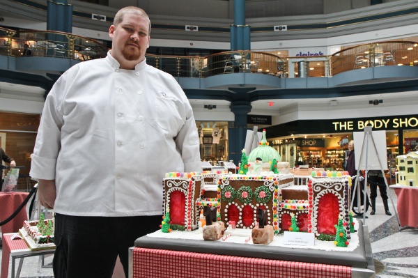 <p>James Rodenbaugh of Br?l?e Catering next to his gingerbread creation of the Please Touch Museum. (Kimberly Paynter/for NewsWorks)</p>
