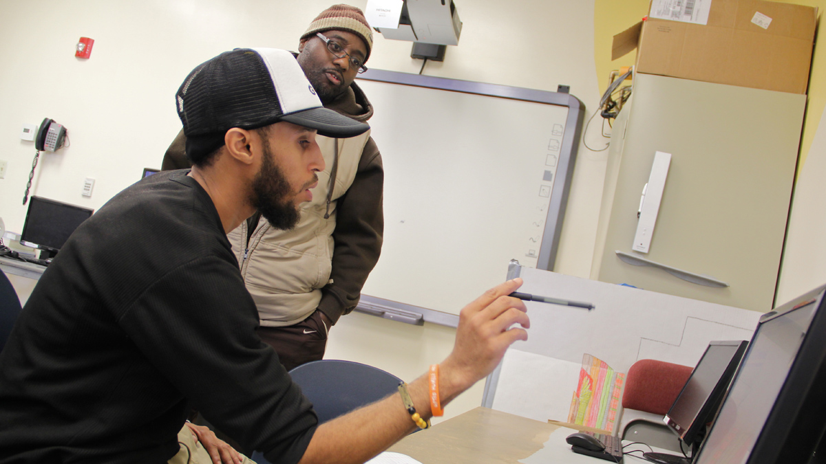  Deval Miller finds out his results on the math section of the soon-expiring version of the GED. Proctor Nate Nixon reviews Miller's scores. (Emma Lee/for NewsWorks) 