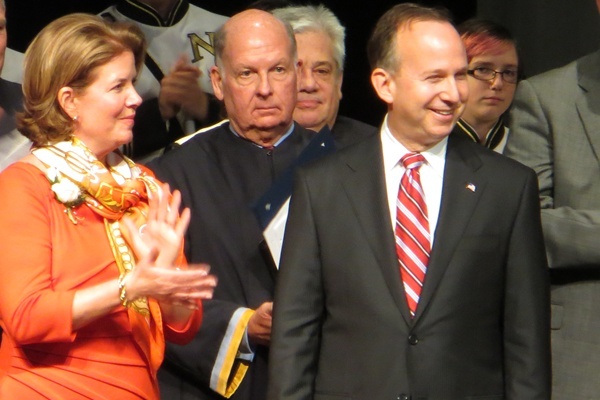 <p><p>Delaware's First Lady Carla Markell claps for her husband as State Supreme Court Chief Justice Myron Steele looks on. (Kim Phan/for NewsWorks)</p></p>
