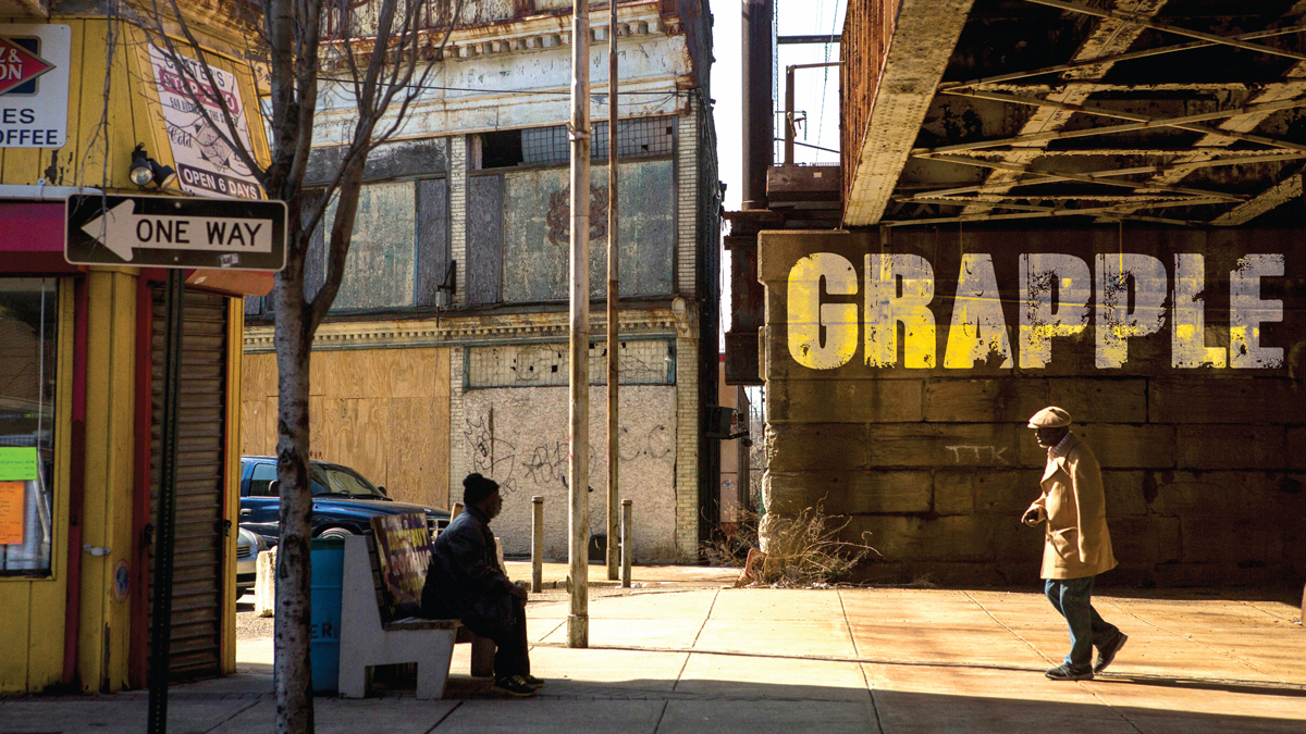  Two men greet each other in front of the triangle building in downtown Chester. (Jessica Kourkounis/For Keystone Crossroads) 