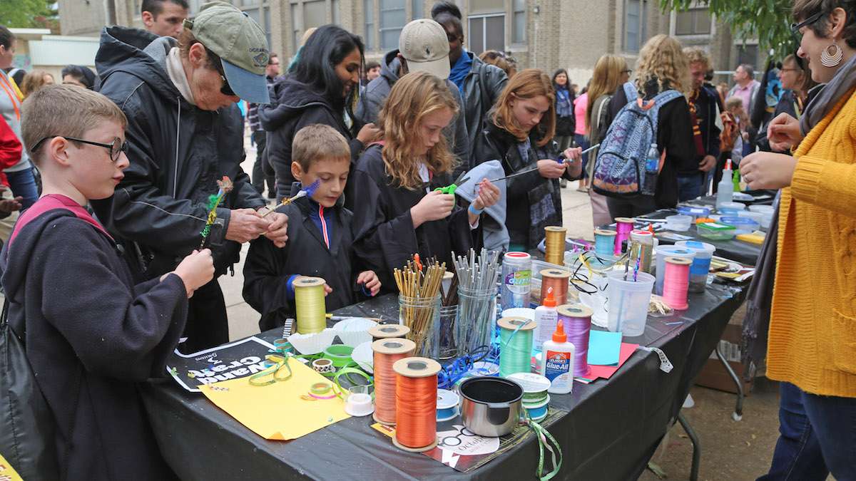 Kids gathered around wand craft station at the Jenks Academy of Witchcraft & Wizardry Kid Zone (Natavan Werbock/for NewsWorks)