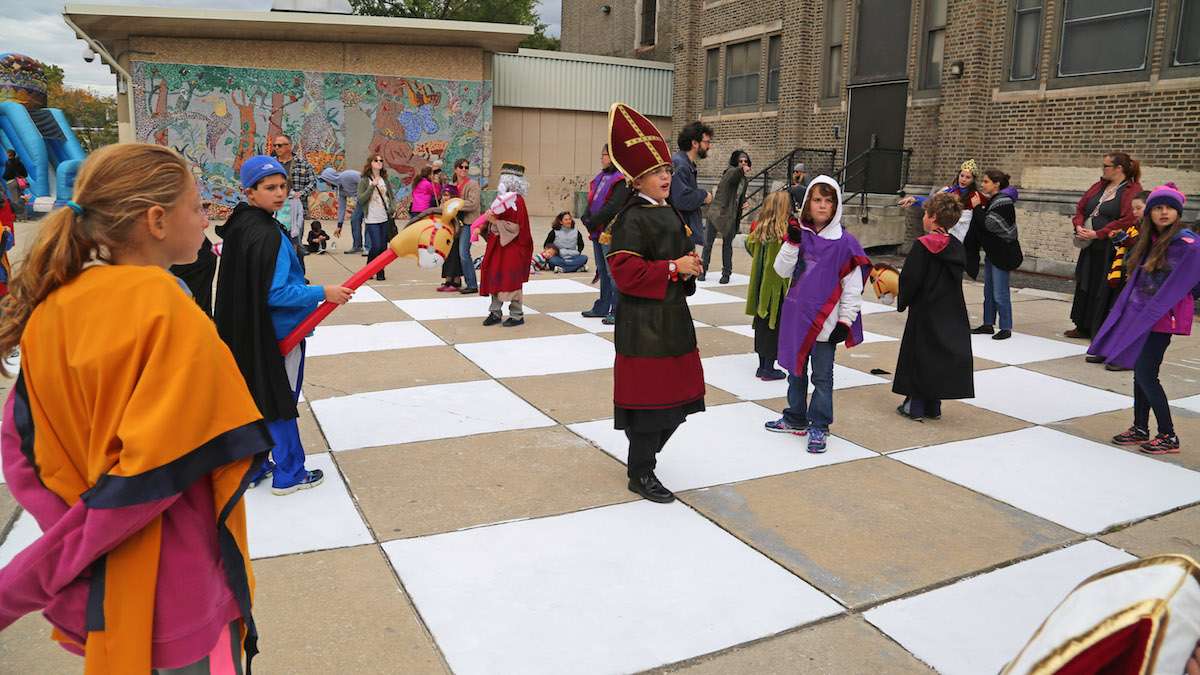 Kids playing Wizard Chess at the Jenks Academy Witchcraft Zone at the Harry Potter Festival (Natavan Werbock/for NewsWorks)