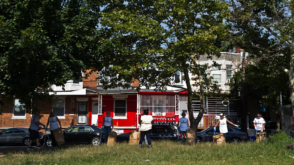  Volunteers clean up Hope Park in Philadelphia’s Kensington Section Thursday morning. (Kimberly Paynter/WHYY) 